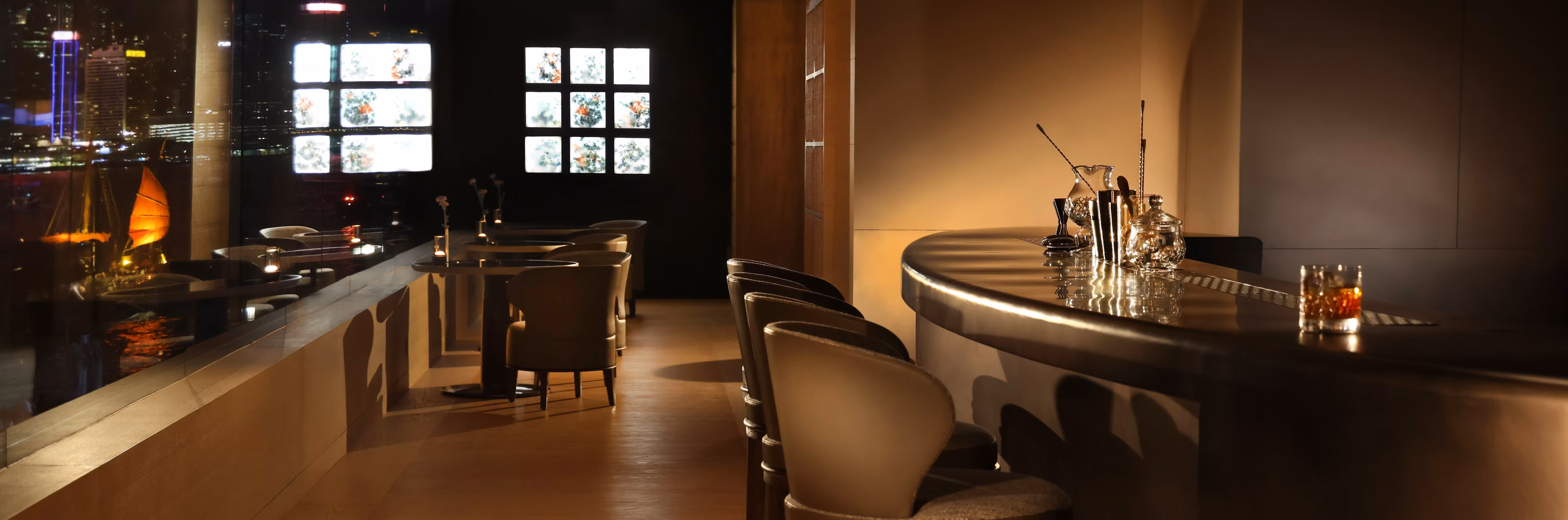 Elegant Regent Club lounge with a curved bar and intimate seating at Regent Bali Canggu